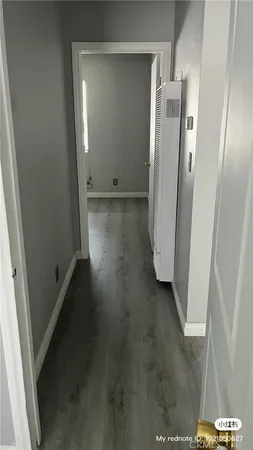 an empty room with wooden floor and a door