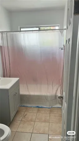 a bathroom with a shower and a tub