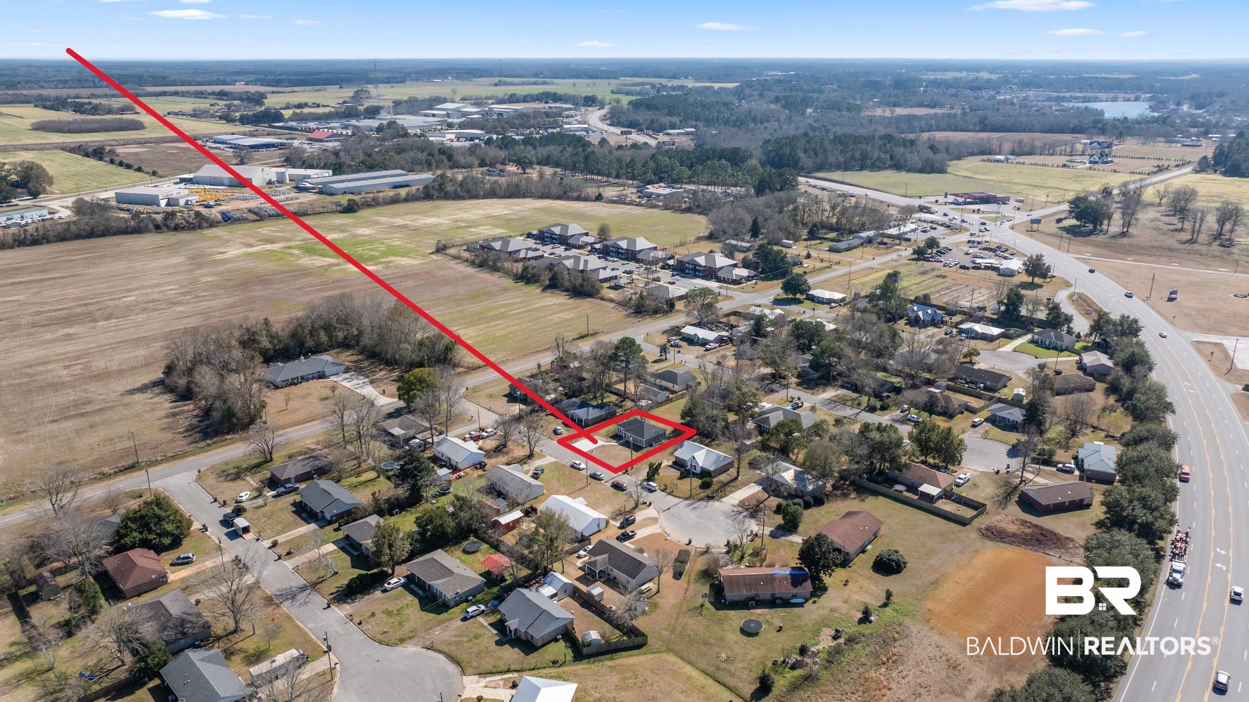76 Fincher Lane Loxley, AL 36551 - Photo 31 of 33 Aerial overview of property's location with nearby suburban area and property boundaries highlighted