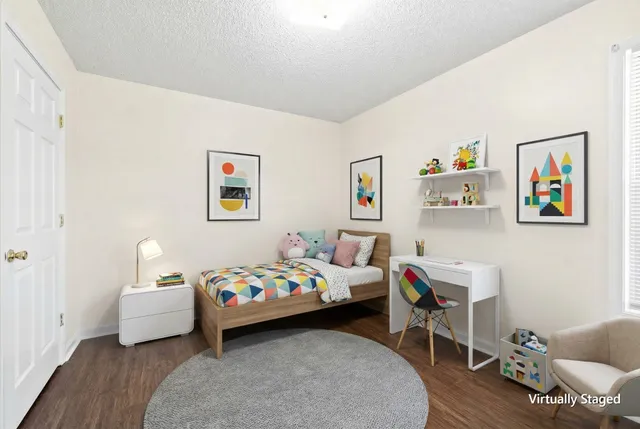 a bedroom with a bed and a couch