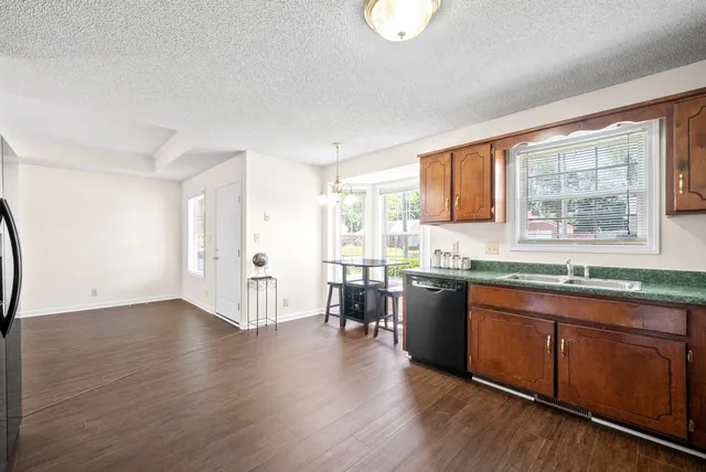 a kitchen with a sink a counter top space and stainless steel appliances