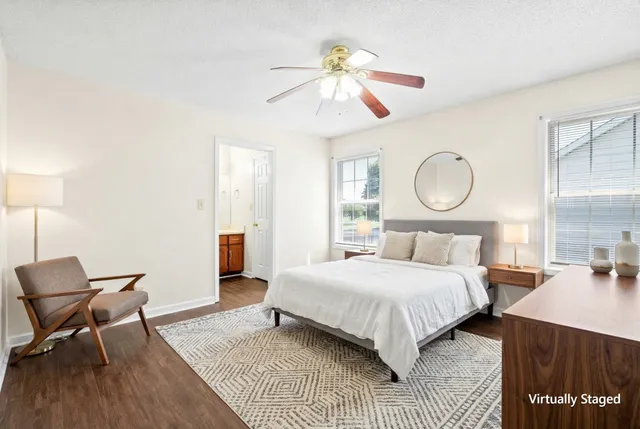 a bedroom with a bed a chandelier and chair