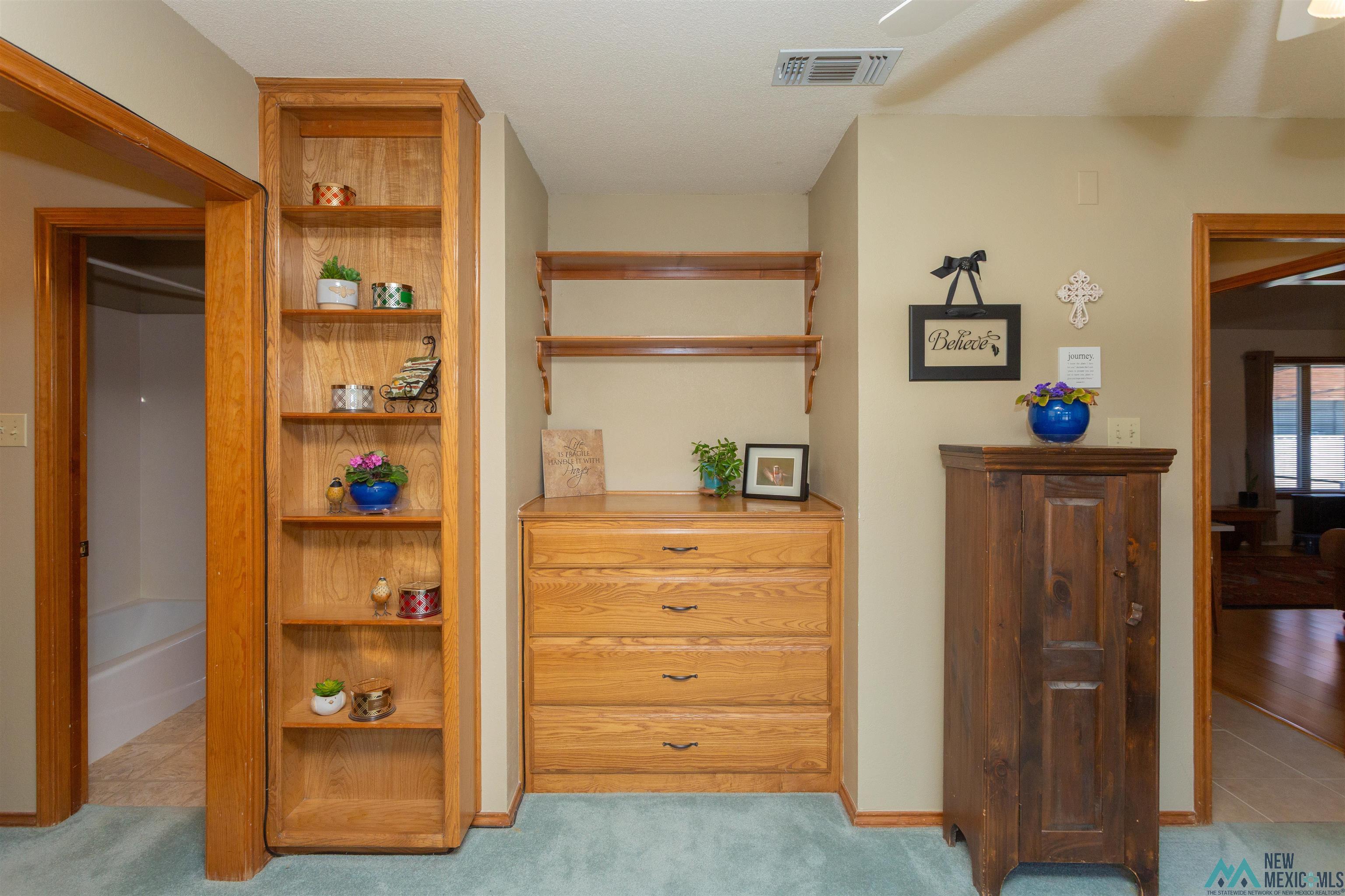 2012 South Haldeman Road Artesia, NM 88210 - Photo 36 of 96 Built-in wooden shelving unit, integrated wooden dresser with four drawers, and a coordinating wooden shelf system