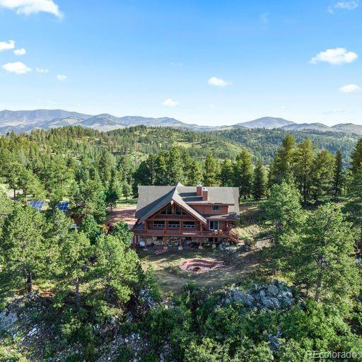 5035 County Road 104 Guffey, CO 80820 - Photo 1 of 40 a view of a house with a mountain in the background