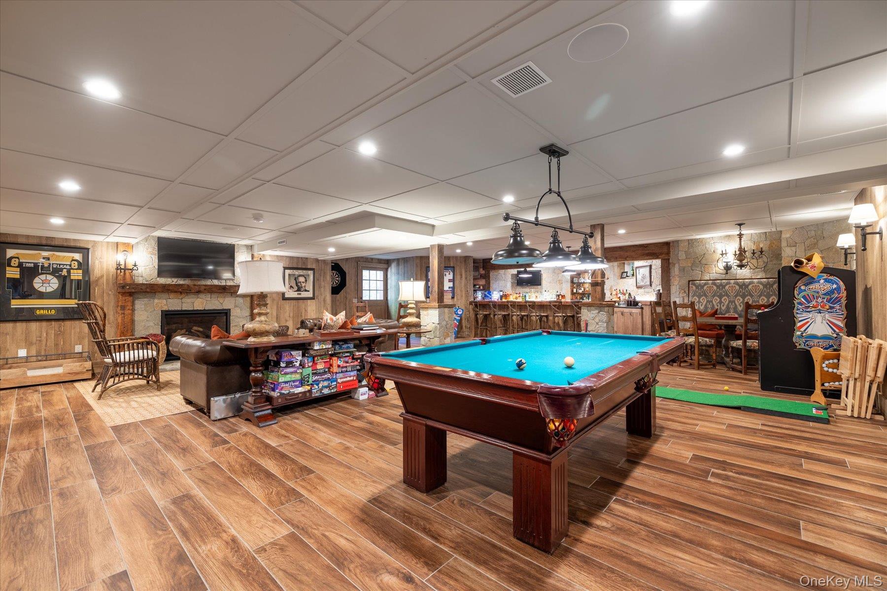 1750 Private Road, Unit 18 Mattituck, NY 11952 - Photo 12 of 49 a living room with furniture a pool table and a fireplace