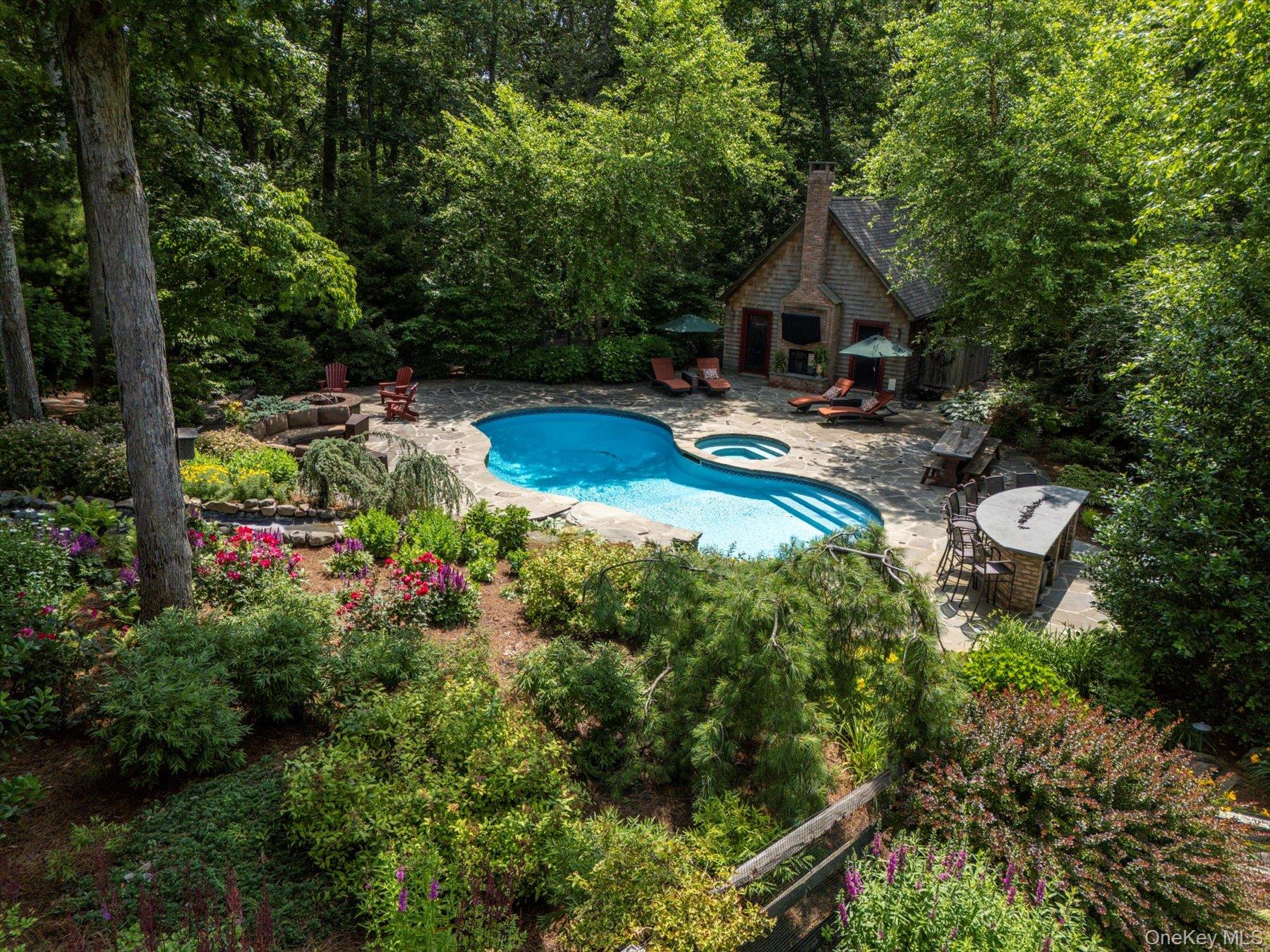 1750 Private Road, Unit 18 Mattituck, NY 11952 - Photo 33 of 49 a aerial view of a house with swimming pool and garden