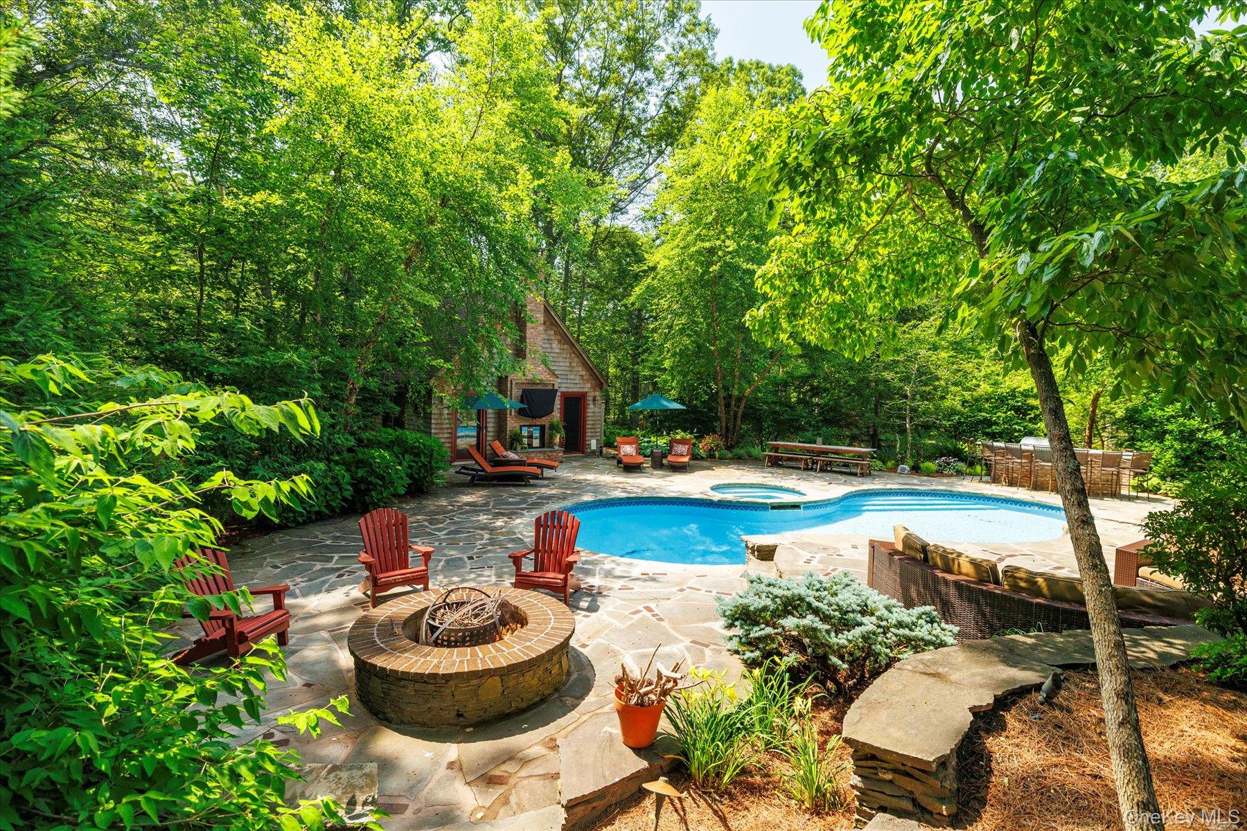 1750 Private Road, Unit 18 Mattituck, NY 11952 - Photo 41 of 49 a balcony with table and chairs potted plants and large tree