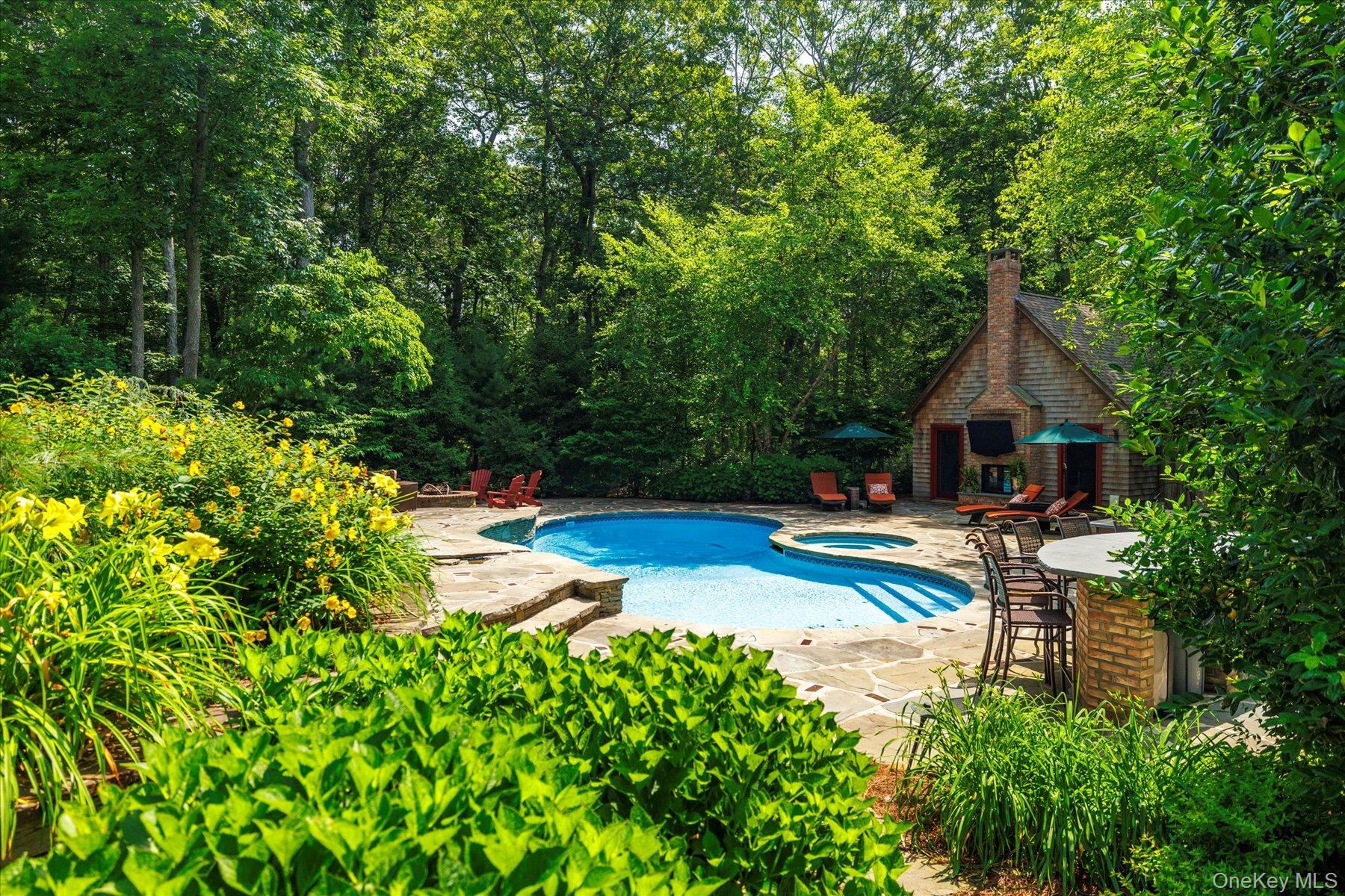 1750 Private Road, Unit 18 Mattituck, NY 11952 - Photo 42 of 49 a view of swimming pool with lawn chairs and plants