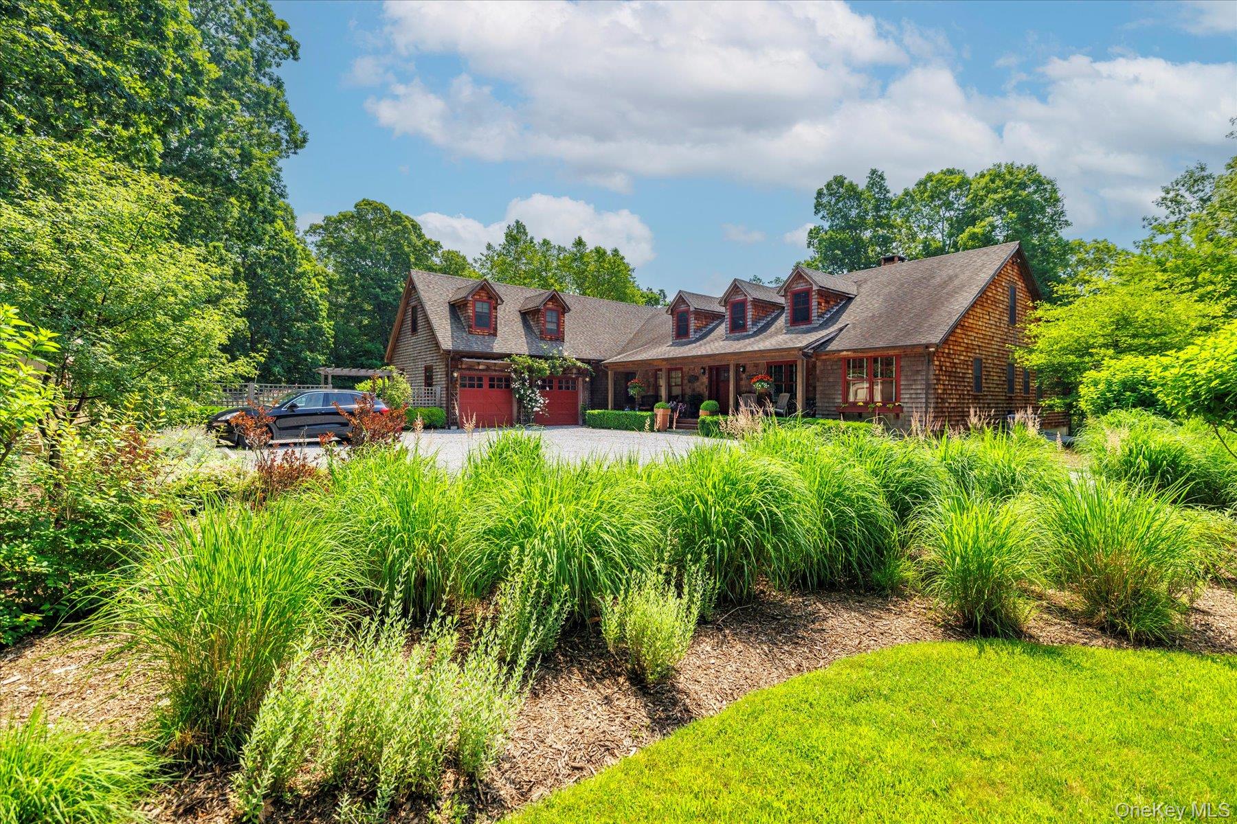 1750 Private Road, Unit 18 Mattituck, NY 11952 - Photo 45 of 49 a view of a house with a yard and potted plants
