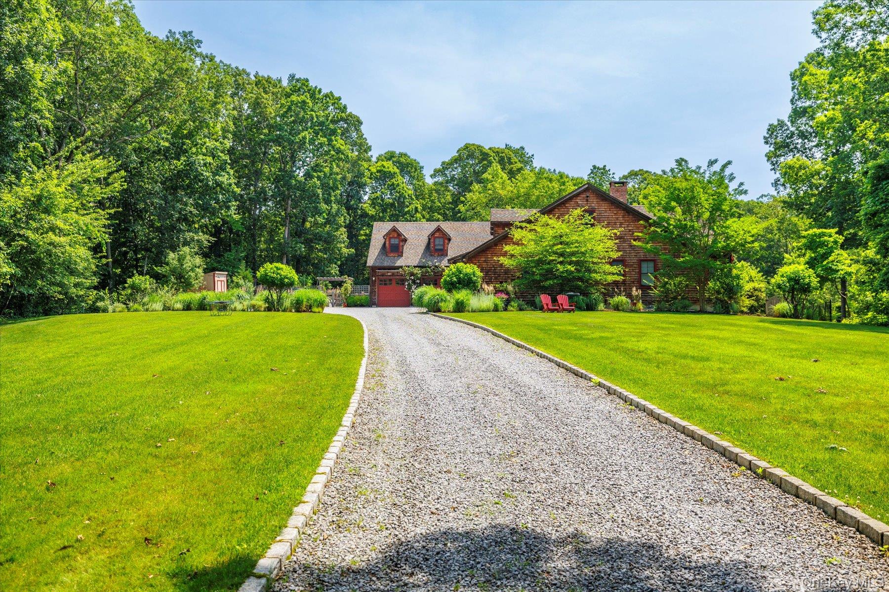 1750 Private Road, Unit 18 Mattituck, NY 11952 - Photo 46 of 49 a view of a garden with a building in the background