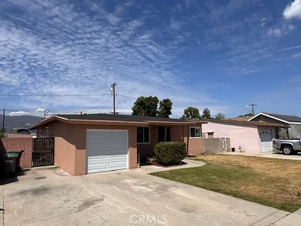 a view of a house with a patio and a yard
