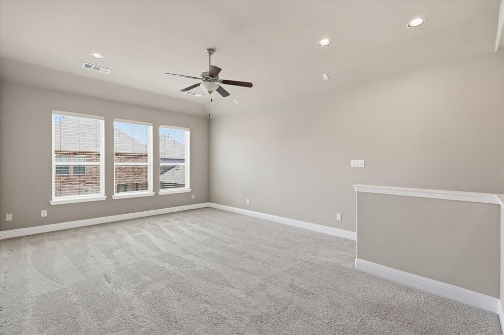 768 Huntingdon Street Coppell, TX 75019 - Photo 25 of 37 Spacious upstairs game room with multiple windows, ceiling fan, and plenty of room to create the perfect hangout space.