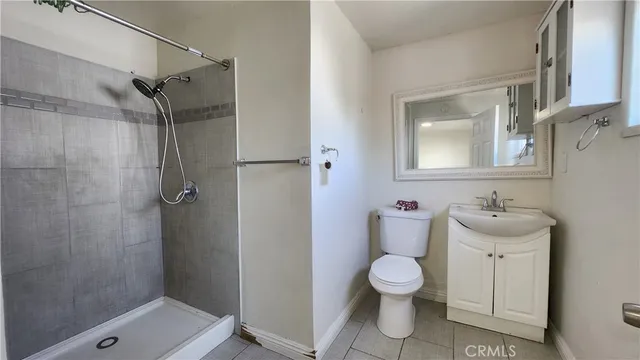 a bathroom with a granite countertop toilet and a shower