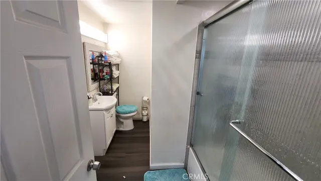 a bathroom with a glass shower door