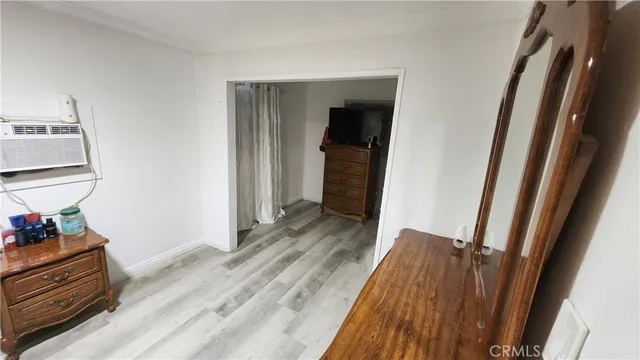 a view of a hallway with wooden floor and closet
