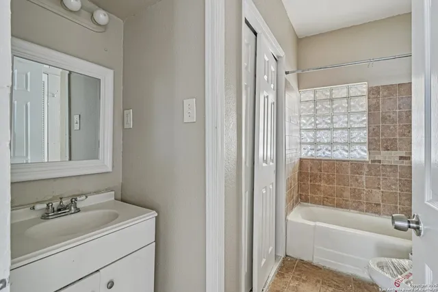 a bathroom with a bathtub and a sink