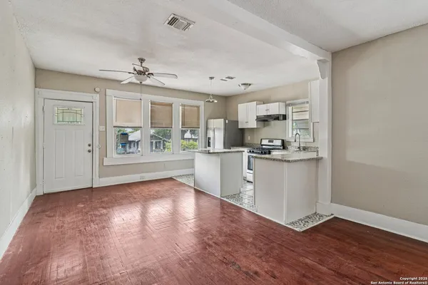 a view of a kitchen with wooden floor and a kitchen