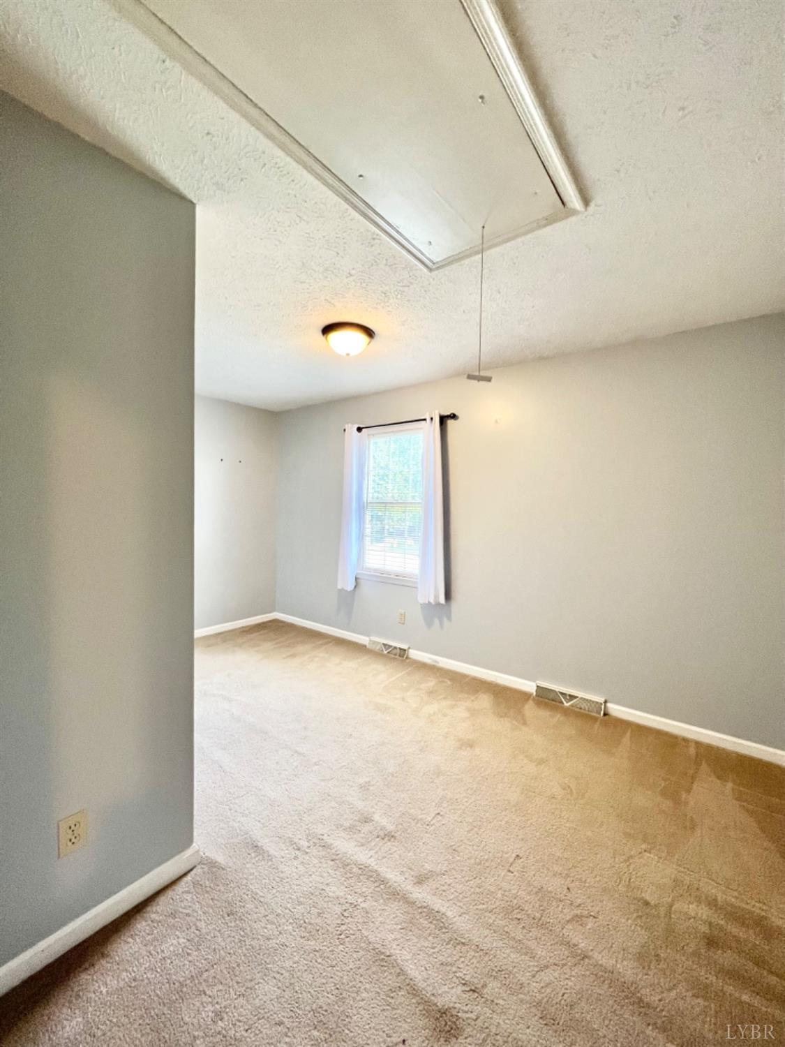 202 Sugar Mill Drive Amherst, VA 24521 - Photo 17 of 41 an empty room with a empty space and windows