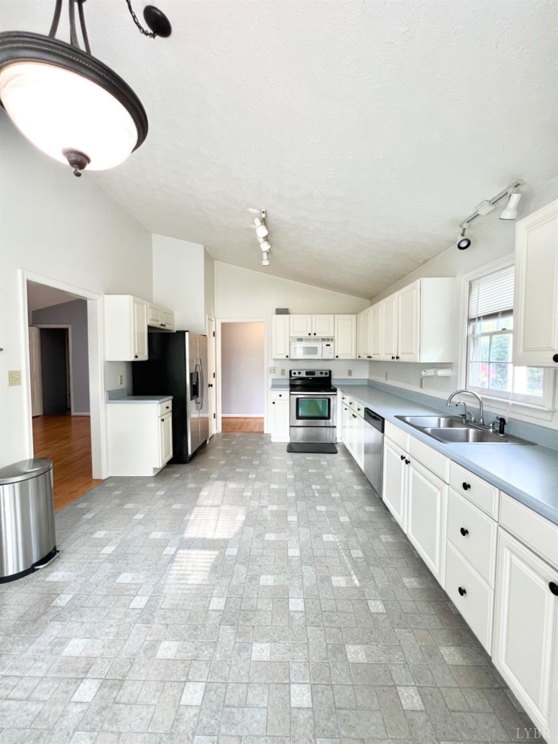 202 Sugar Mill Drive Amherst, VA 24521 - Photo 2 of 41 a large kitchen with stainless steel appliances kitchen island granite countertop a refrigerator and a stove top oven