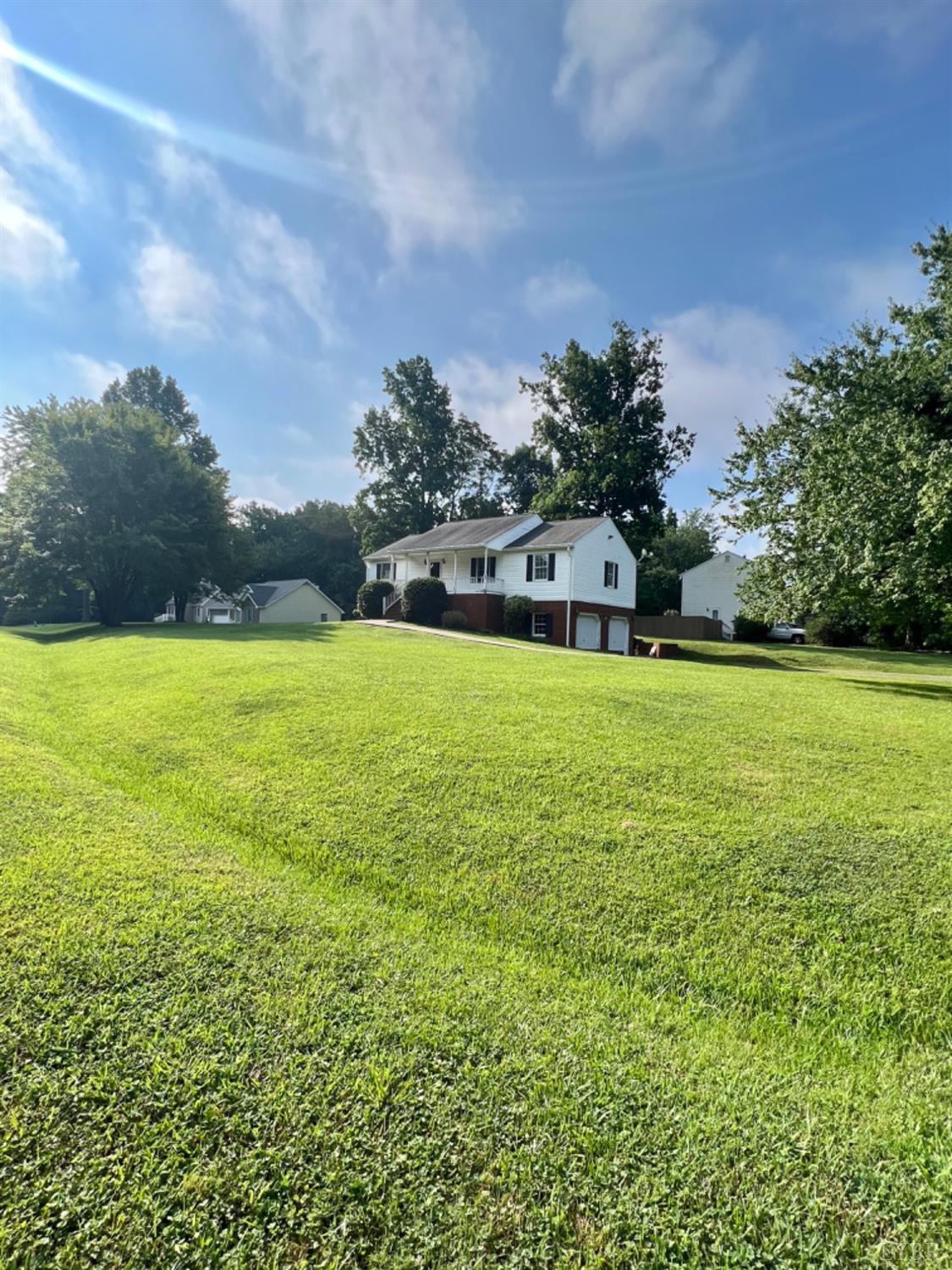 202 Sugar Mill Drive Amherst, VA 24521 - Photo 23 of 41 a view of a large pool with lawn chairs under an umbrella
