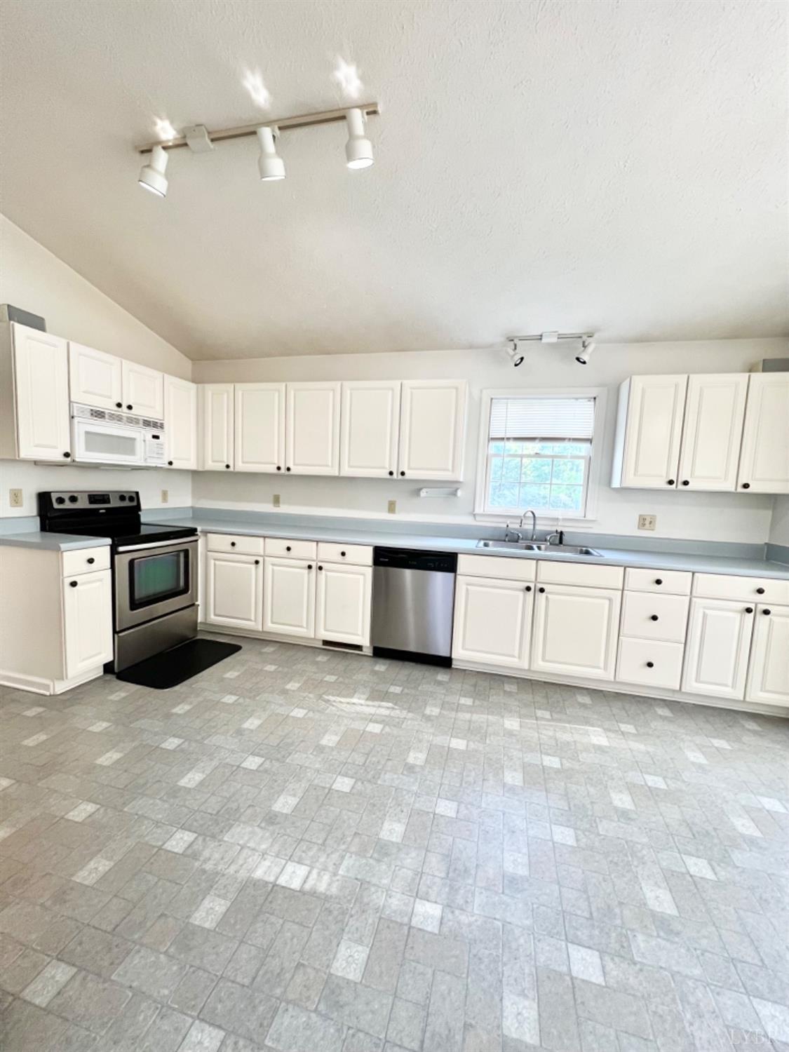 202 Sugar Mill Drive Amherst, VA 24521 - Photo 5 of 41 a large kitchen with stainless steel appliances granite countertop a stove sink and cabinets