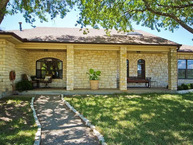 a living room with furniture and a dining table
