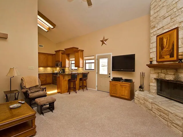 a kitchen with stainless steel appliances granite countertop a stove top oven a sink dishwasher and a microwave oven with cabinets