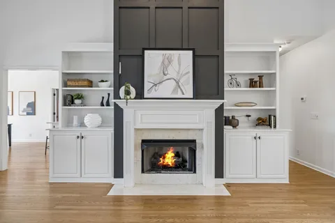a living room with furniture fireplace and flat screen tv