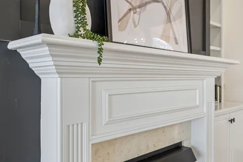 a kitchen with white cabinets and white appliances