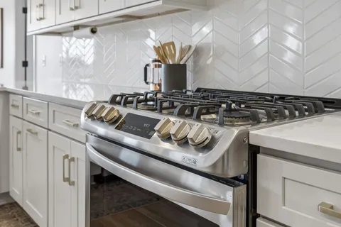 a kitchen with a sink and a mirror