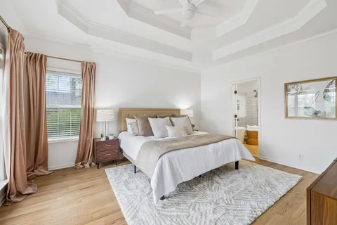 a view of a livingroom with wooden floor and white walls