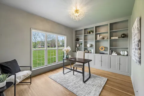a living room with furniture fireplace and wooden floor