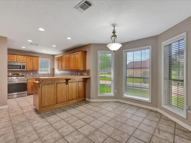a kitchen with cabinets appliances and a sink