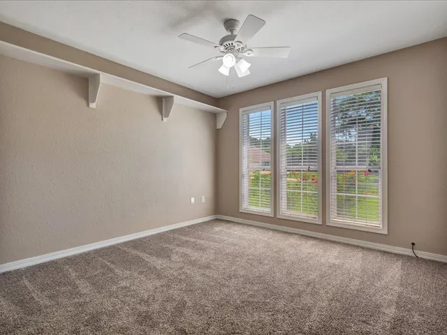 an aerial view of a house with swimming pool and garden