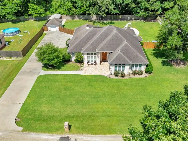 a aerial view of a house with swimming pool garden and outdoor seating