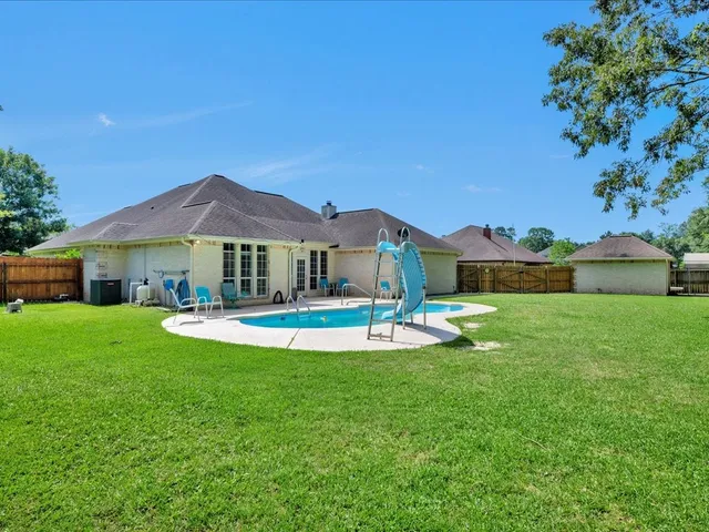 a front view of house with yard and green space