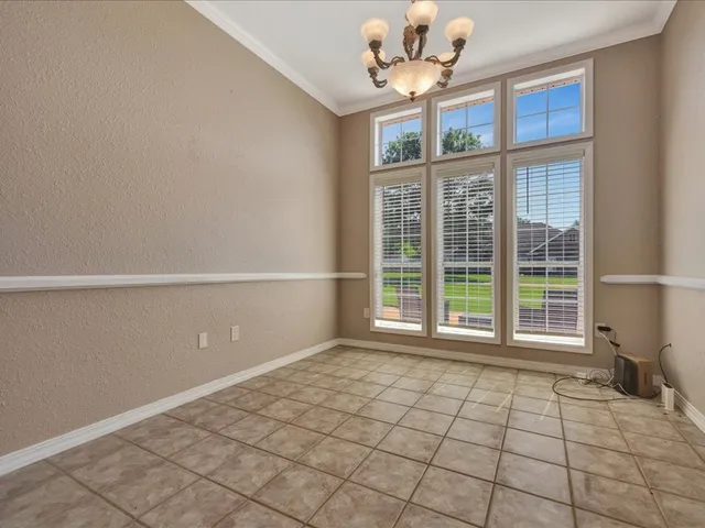 a large kitchen with kitchen island granite countertop a stove a sink a counter space and cabinets