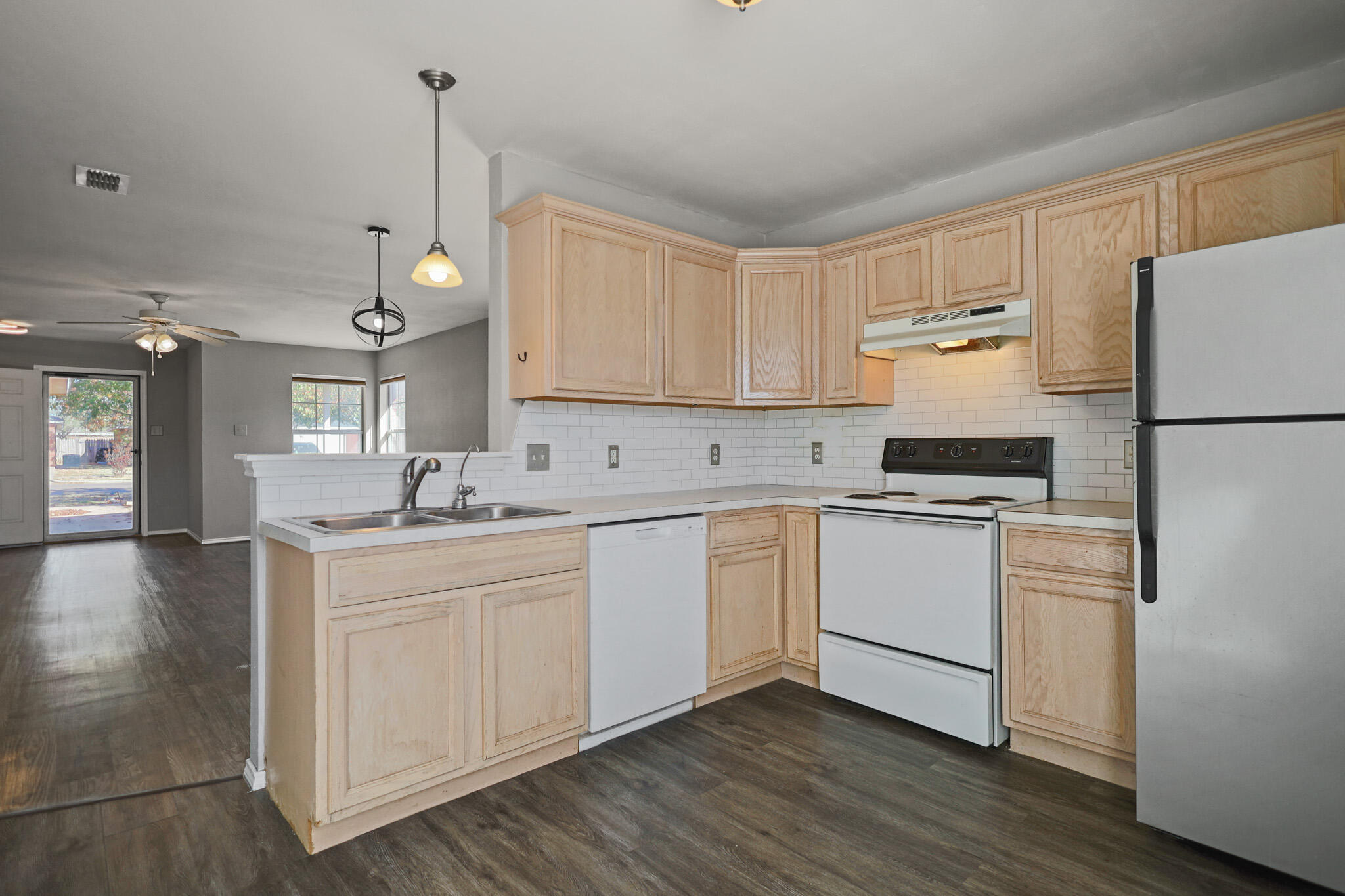 5903 10th Street, Unit 2 Lubbock, TX 79416 - Photo 11 of 47 a kitchen with white cabinets and white appliances