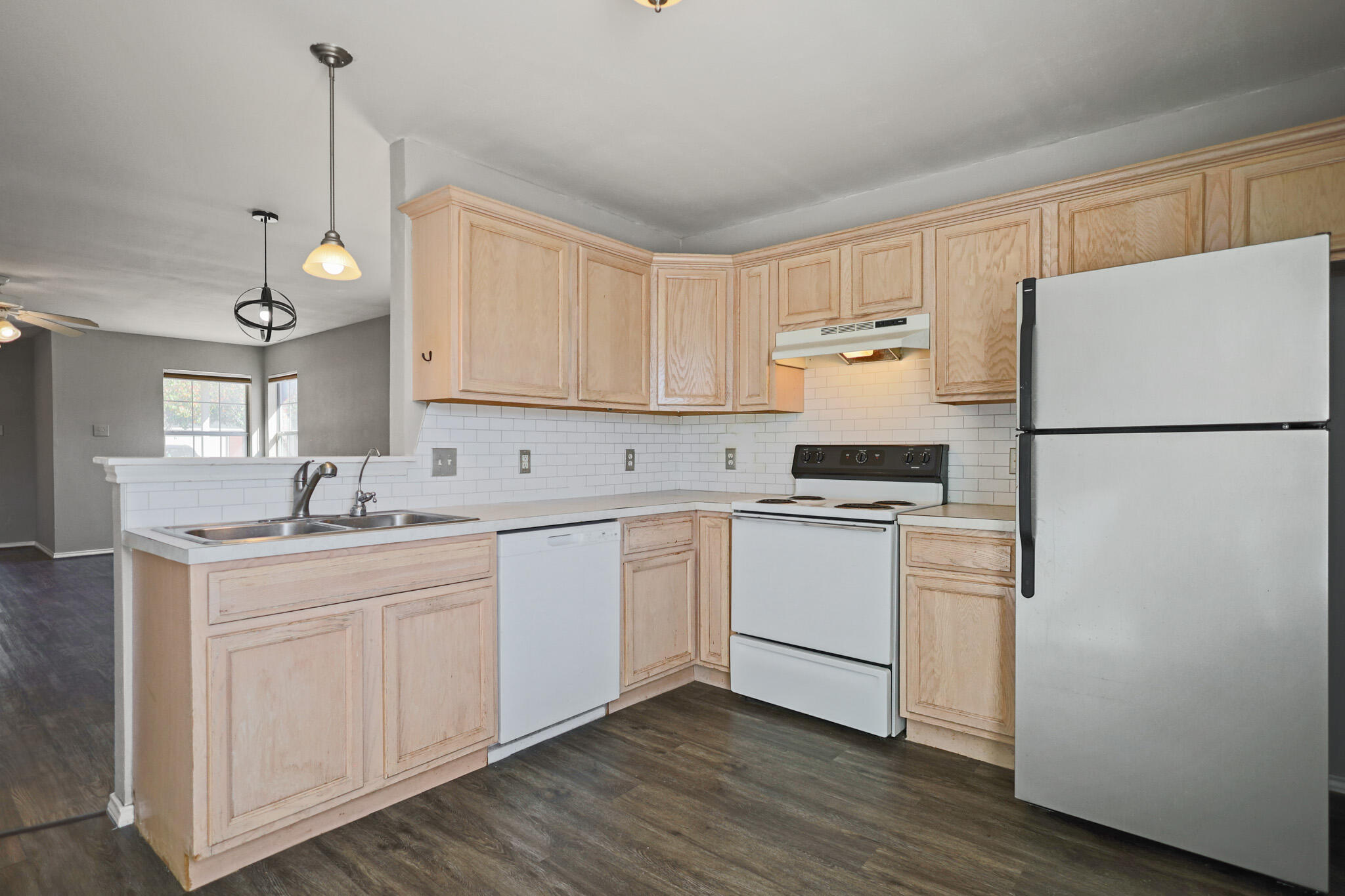 5903 10th Street, Unit 2 Lubbock, TX 79416 - Photo 12 of 47 a kitchen with sink refrigerator and cabinets