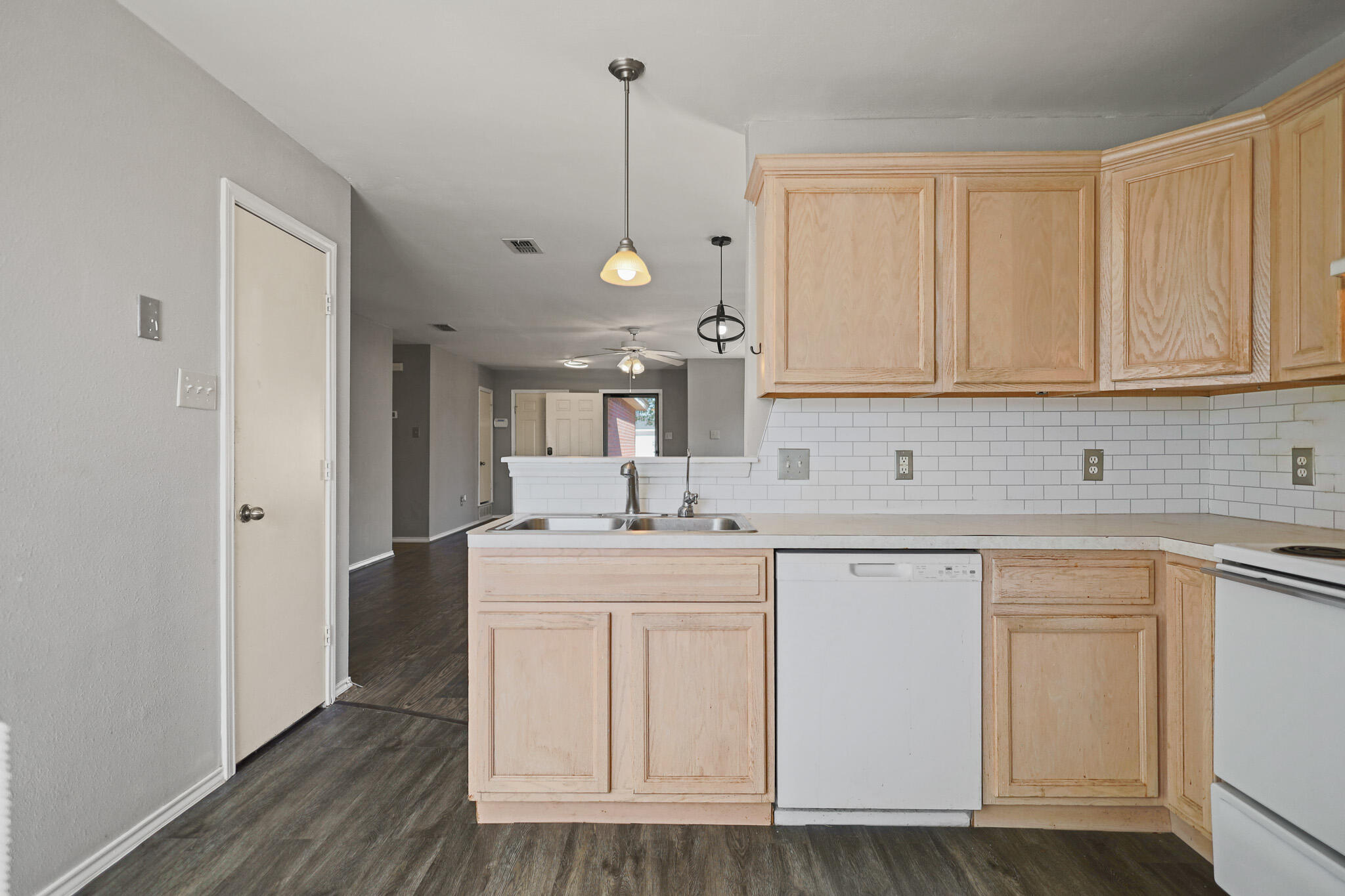 5903 10th Street, Unit 2 Lubbock, TX 79416 - Photo 13 of 47 a kitchen with white cabinets and sink
