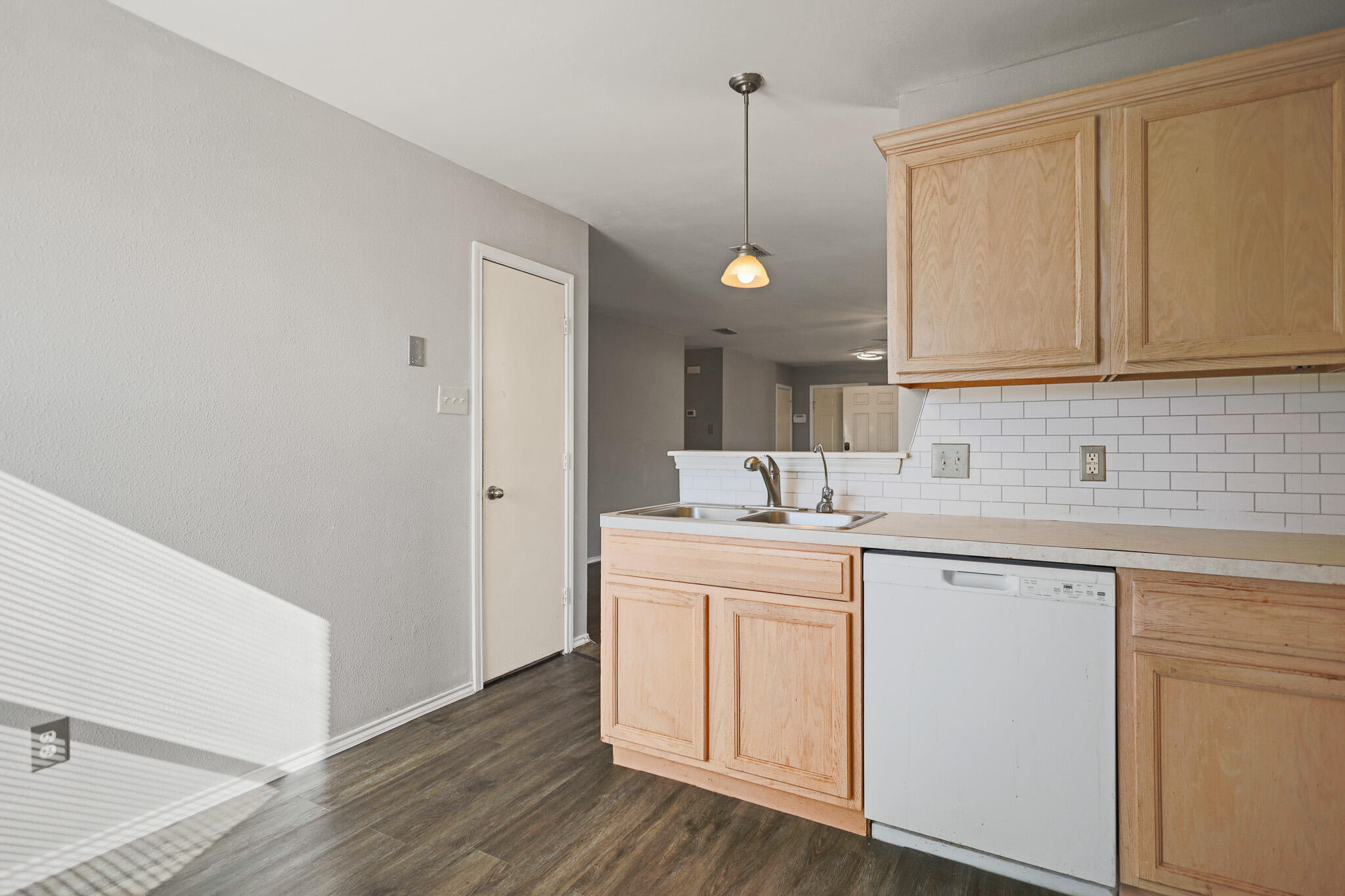 5903 10th Street, Unit 2 Lubbock, TX 79416 - Photo 14 of 47 a kitchen with a sink cabinets and wooden floor