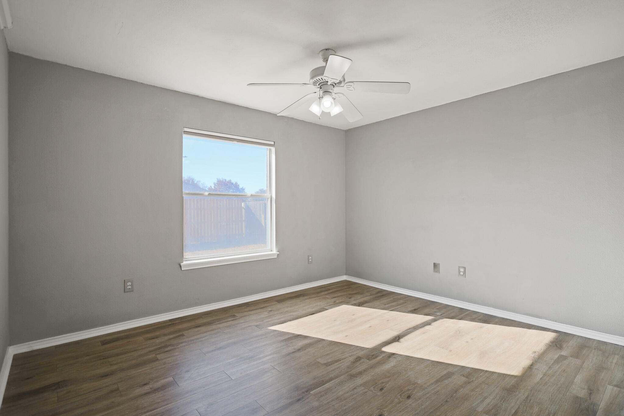 5903 10th Street, Unit 2 Lubbock, TX 79416 - Photo 17 of 47 wooden floor in an empty room with a window