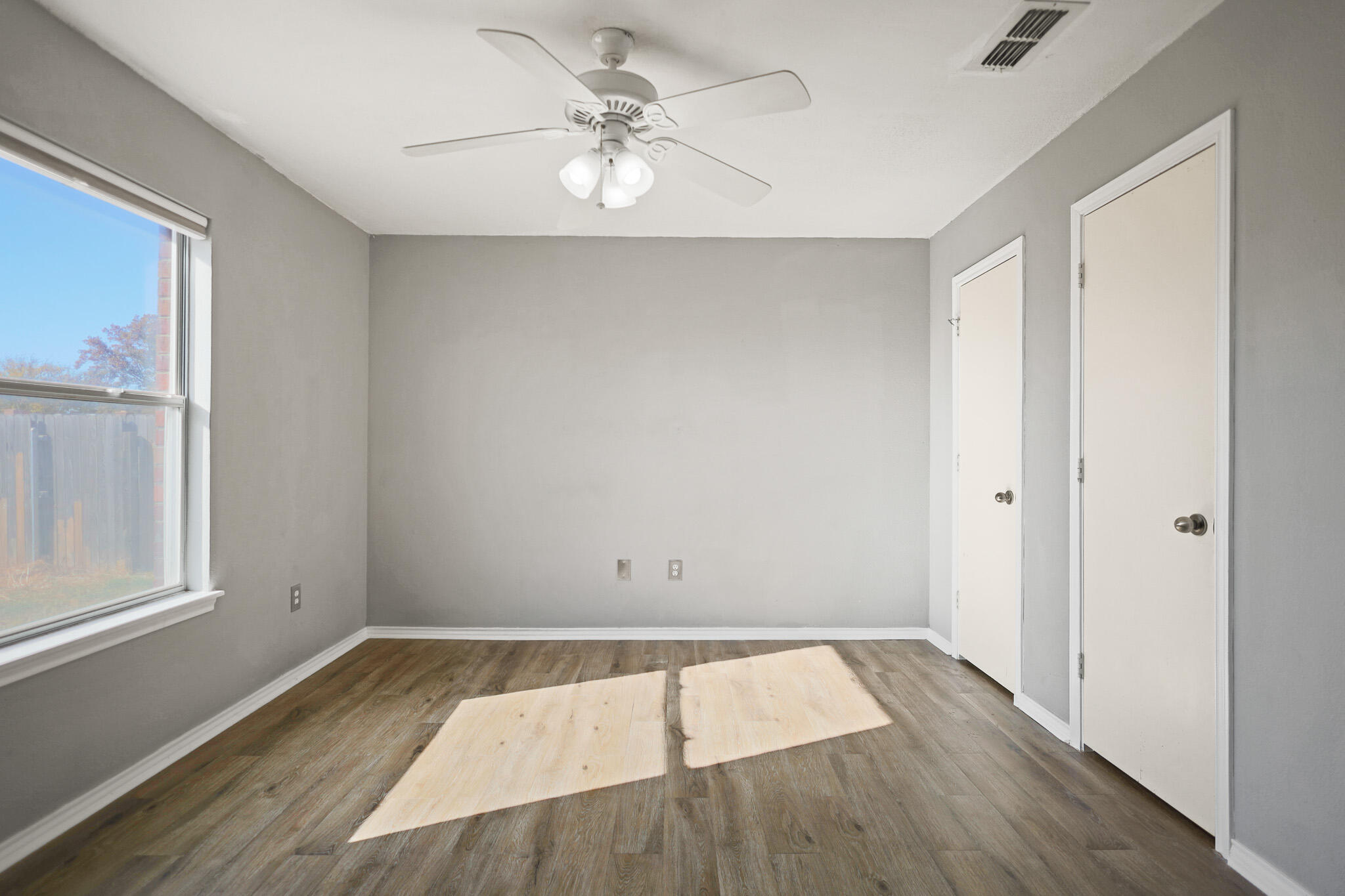 5903 10th Street, Unit 2 Lubbock, TX 79416 - Photo 18 of 47 wooden floor in an empty room with a window