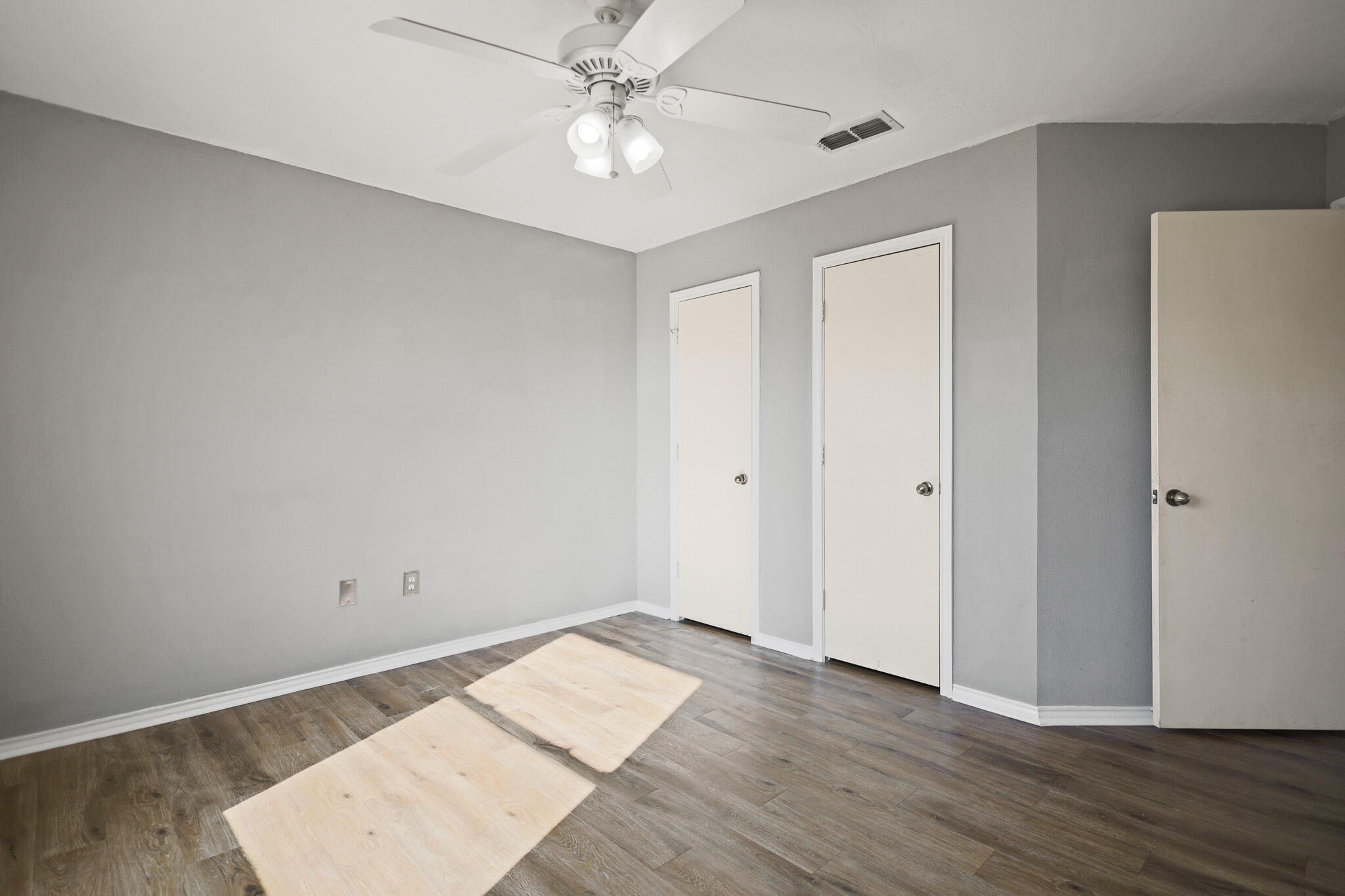 5903 10th Street, Unit 2 Lubbock, TX 79416 - Photo 19 of 47 a view of a room with wooden floor and ceiling fan