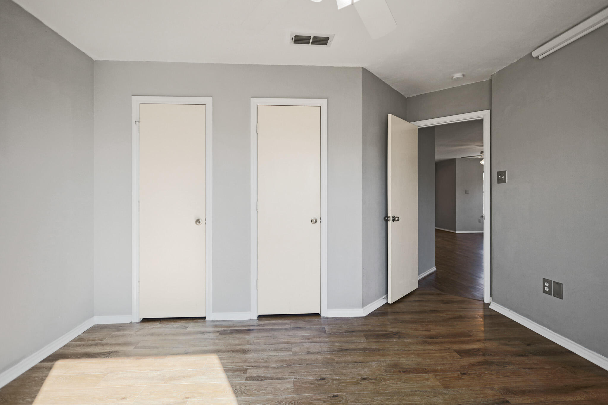 5903 10th Street, Unit 2 Lubbock, TX 79416 - Photo 20 of 47 a view of an empty room with wooden floor