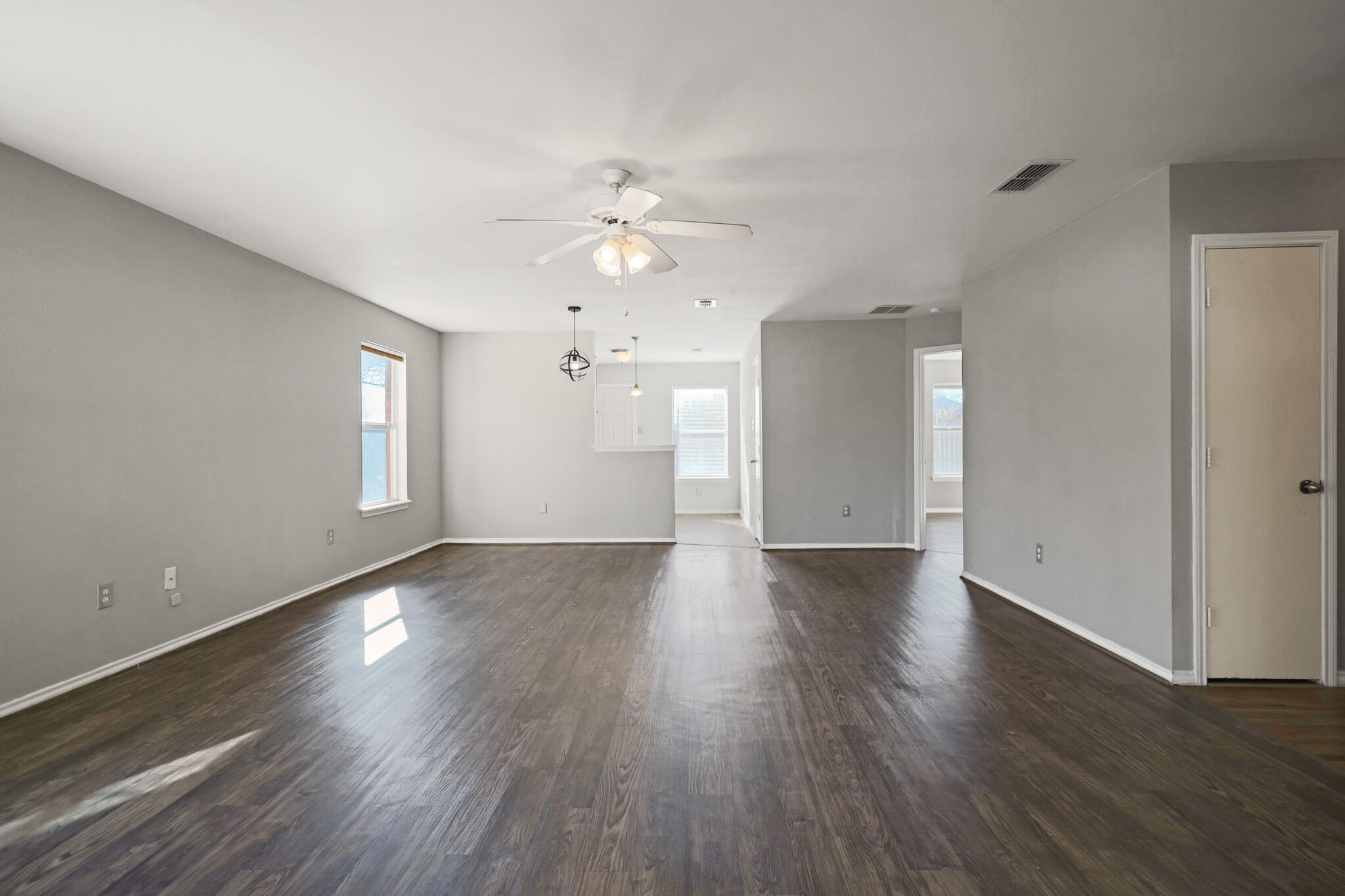 5903 10th Street, Unit 2 Lubbock, TX 79416 - Photo 2 of 47 a view of an empty room with wooden floor and a window