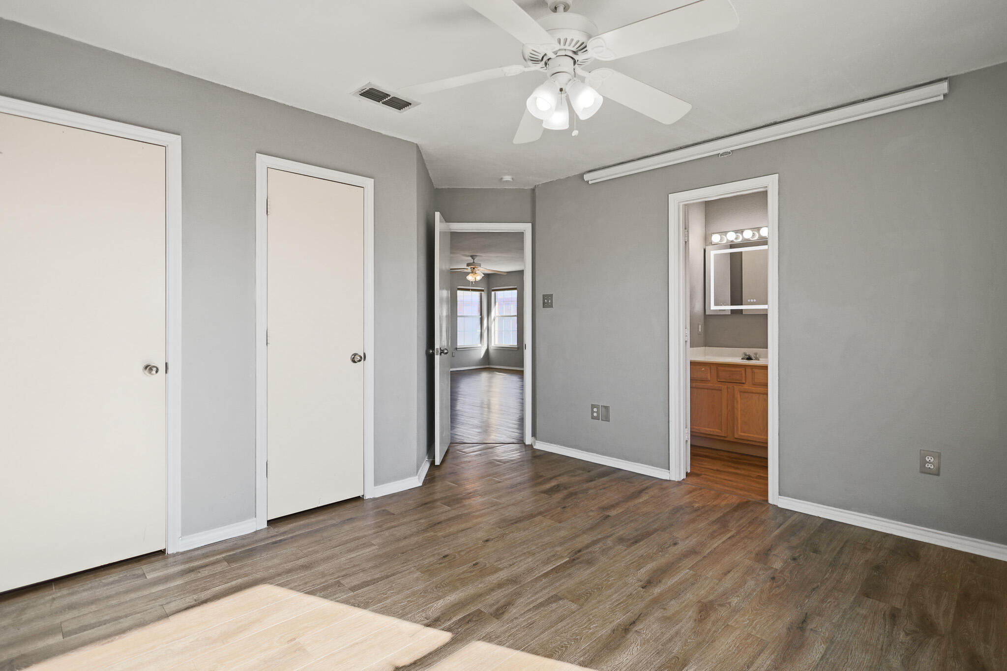 5903 10th Street, Unit 2 Lubbock, TX 79416 - Photo 21 of 47 a view of an empty room with wooden floor