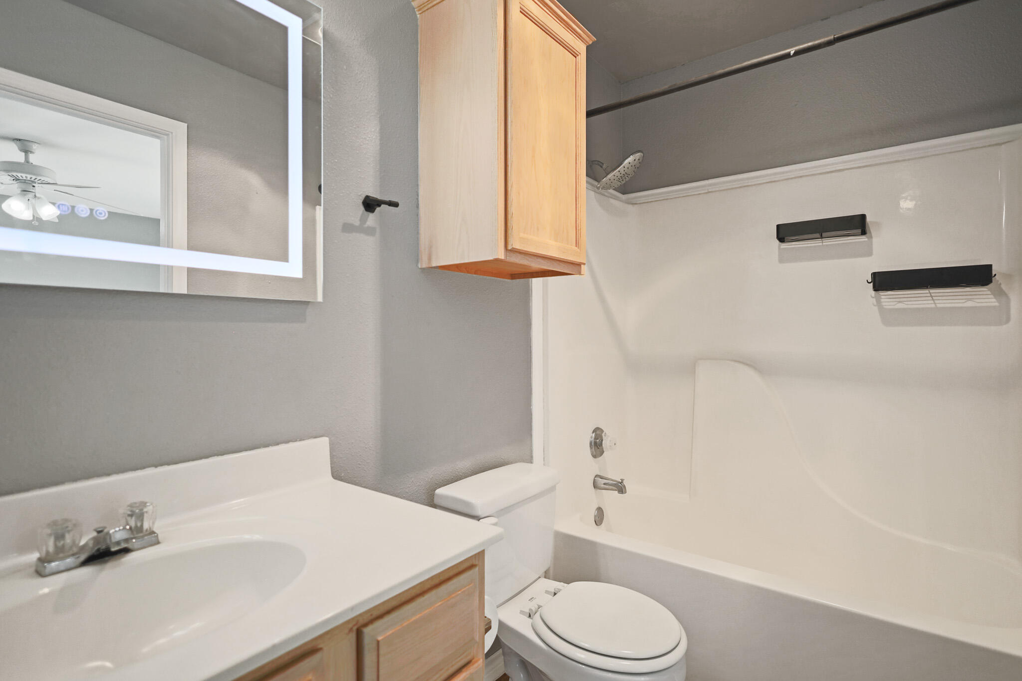 5903 10th Street, Unit 2 Lubbock, TX 79416 - Photo 26 of 47 a bathroom with a sink a toilet and shower