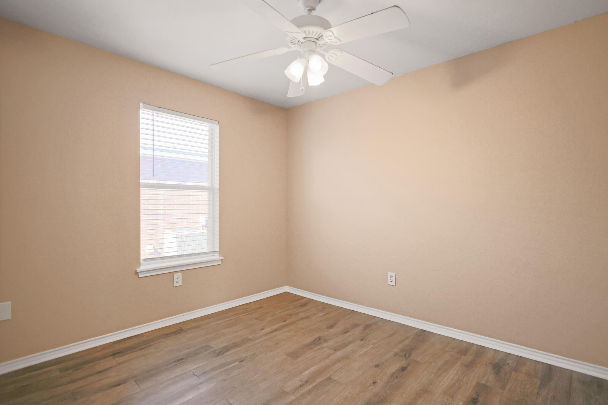 5903 10th Street, Unit 2 Lubbock, TX 79416 - Photo 27 of 47 an empty room with a window and wooden floor