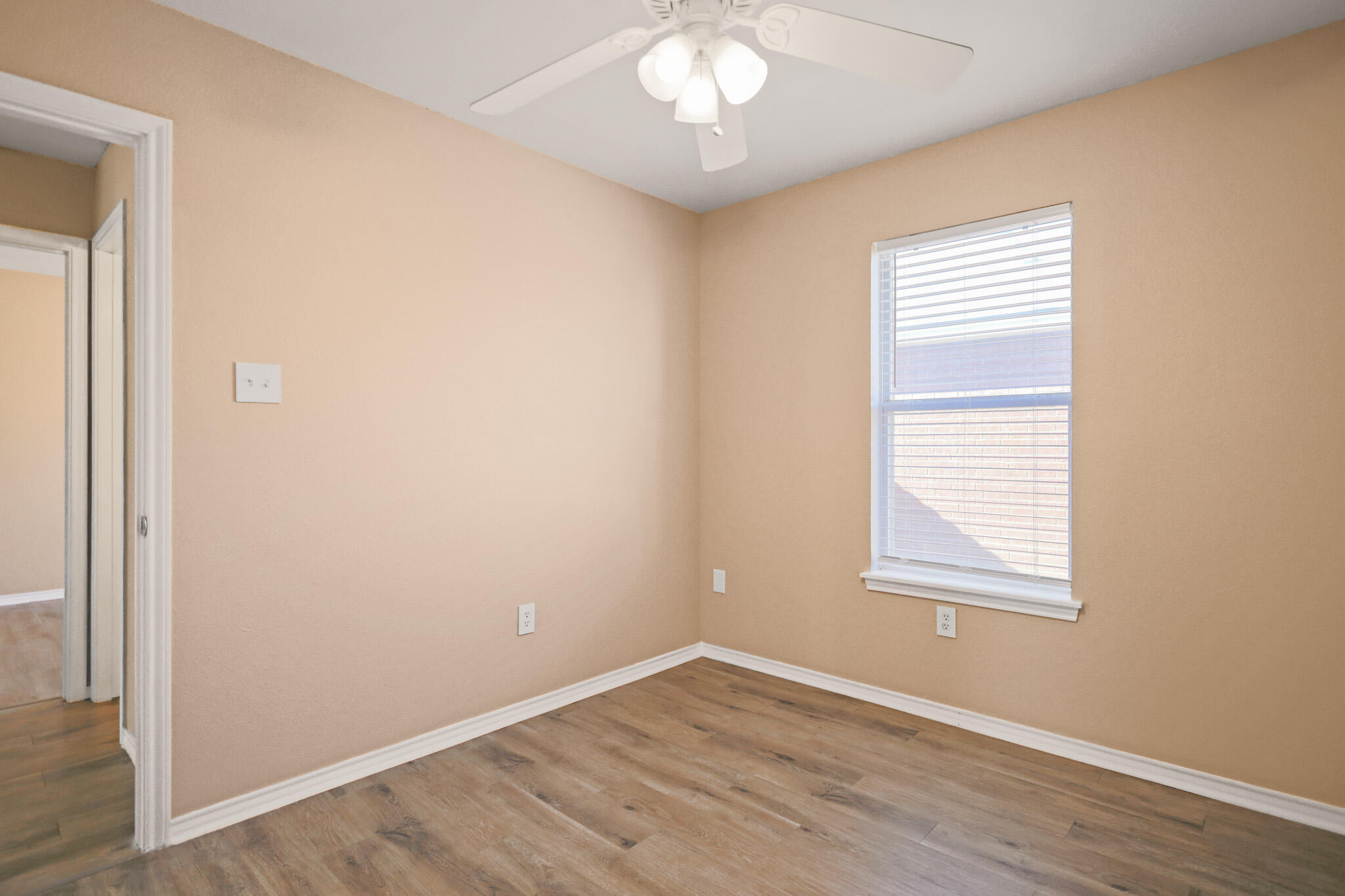 5903 10th Street, Unit 2 Lubbock, TX 79416 - Photo 28 of 47 an empty room with wooden floor and windows